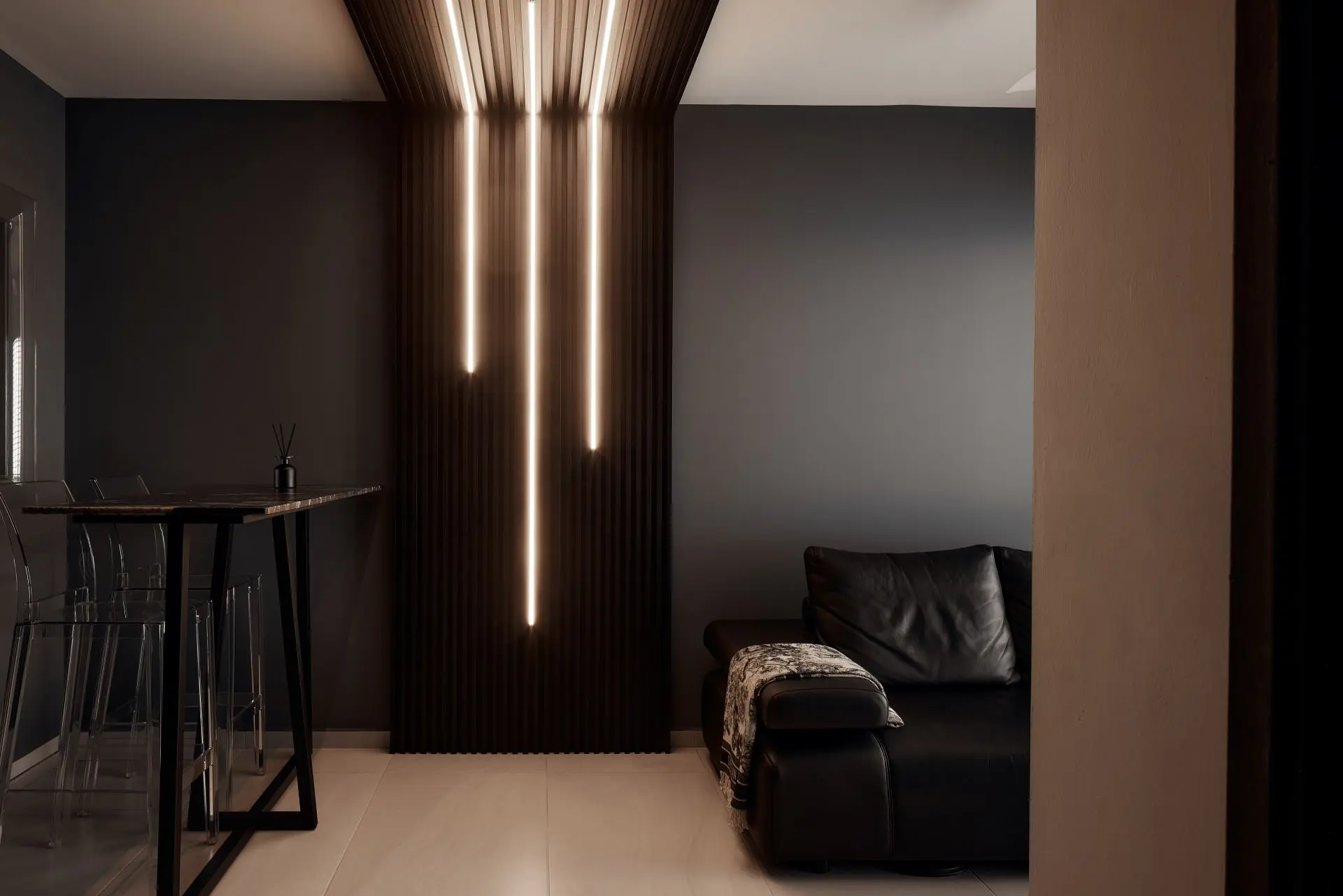 Modern living room with ambient lighting and furniture.